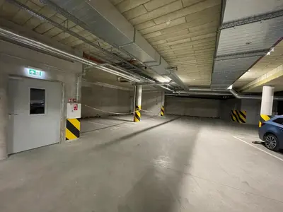 an empty parking garage with a car parked in it at ART Uzupis Apartment in City center in Vilnius