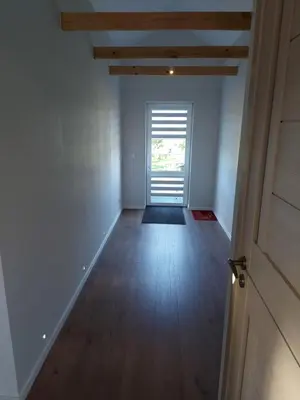 an empty hallway with a door and a window at Apartments MILENA in Druskininkai