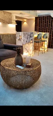 a circular coffee table in a room with a couch at Luxury Queen V apartment with Jacuzzi in Kaunas