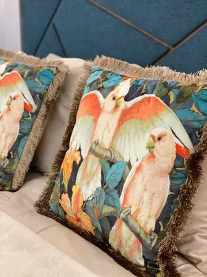 two pillows with birds on them sitting on a bed at Luxury Queen V apartment with Jacuzzi in Kaunas