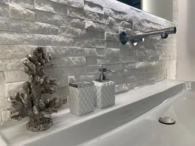 a bathroom sink with a faucet and a plant on it at Luxury Queen V apartment with Jacuzzi in Kaunas