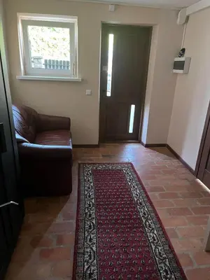a living room with a couch and a rug at Pušynas1 in Anykščiai