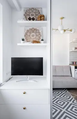 a living room with a tv on a white dresser at Butas nuomai Šiauliuose in Šiauliai