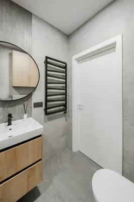 a bathroom with a white sink and a mirror at Brand New Mindaugas Luxury Designer Apart in Vilnius