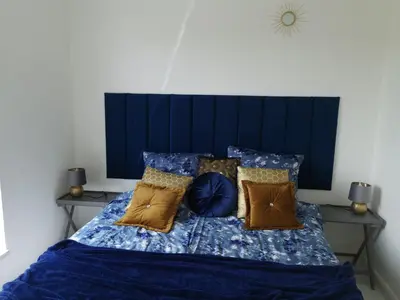 a bedroom with a blue bed with pillows at Luxury Penthouse with Large Terrace & Panoramic Old Town View in Vilnius