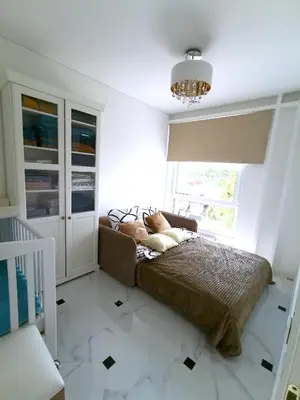 a bedroom with a bed and a window and a chandelier at Luxury Penthouse with Large Terrace & Panoramic Old Town View in Vilnius