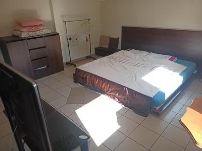 a bedroom with a bed and a laptop on the floor at Vilnius Cat Friendly in Vilnius