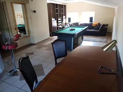a living room with a pool table and a couch at Vilnius Cat Friendly in Vilnius