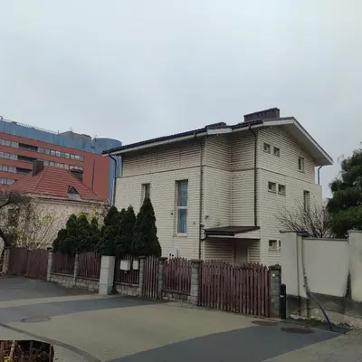 an older house with a fence in front of it at Vilnius Cat Friendly in Vilnius