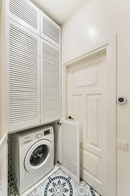 a laundry room with a washing machine and a door at Stylish apartment in the heart of Kaunas Old Town in Kaunas