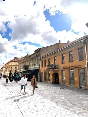 two men walking down a street in a city at Stylish apartment in the heart of Kaunas Old Town in Kaunas