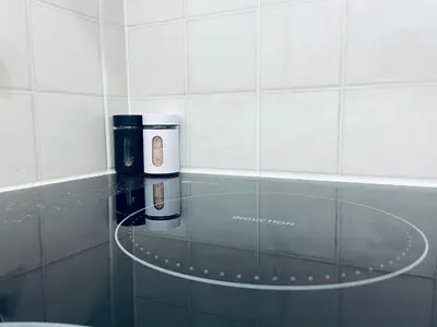 a glass counter top with a coffee maker on it at Oldtown apartment in Vilnius