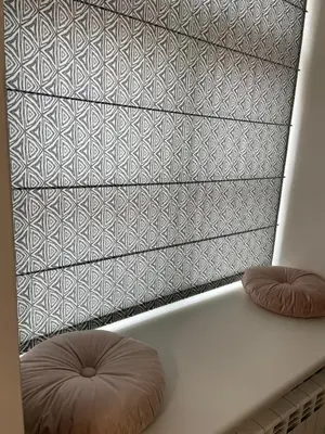 a white bed with two pillows in front of a wall at Oldtown apartment in Vilnius