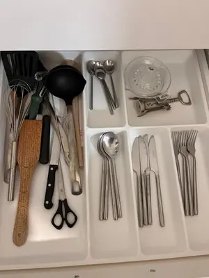 a white tray filled with utensils in a drawer at Oldtown apartment in Vilnius
