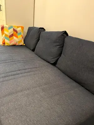 a gray couch with two pillows on top of it at Oldtown apartment in Vilnius