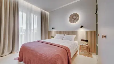 a bedroom with a bed and a large window at #stayhere - Brand New Unique Designer 1BDR in Trendy Neighbourhood in Vilnius