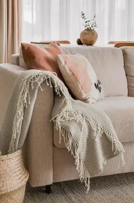 a couch with pillows on it in a living room at #stayhere - Brand New Unique Designer 1BDR in Trendy Neighbourhood in Vilnius