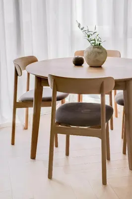 a wooden table with a chair and a table with a plant on it at #stayhere - Brand New Unique Designer 1BDR in Trendy Neighbourhood in Vilnius