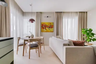 a living room with a white couch and a table at #stayhere - Brand New Unique Designer 1BDR in Trendy Neighbourhood in Vilnius