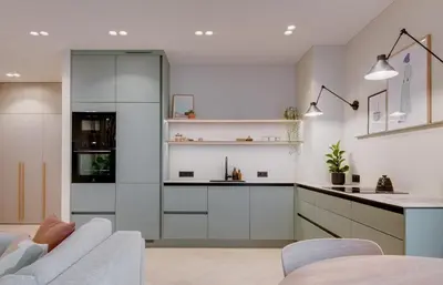 a kitchen with white cabinets and a couch at #stayhere - Brand New Unique Designer 1BDR in Trendy Neighbourhood in Vilnius