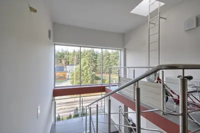 a staircase in a building with a large window at Apartamentai Aqua in Druskininkai