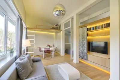 a living room with a couch and a table at Apartamentai Aqua in Druskininkai