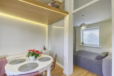 a small room with a table and a bed at Apartamentai Aqua in Druskininkai