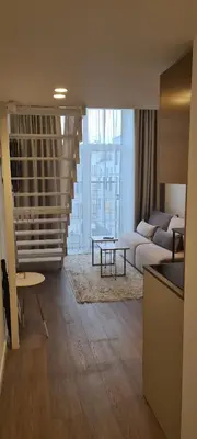 a living room with a couch and a table at Stay in Kaunas & Radio City in Kaunas