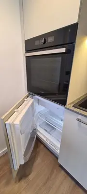 an open refrigerator with a microwave in a kitchen at Stay in Kaunas & Radio City in Kaunas