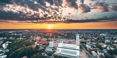 an aerial view of a city with the sun setting at Stay in Kaunas & Radio City in Kaunas