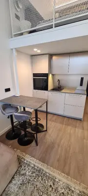 a kitchen with a table and chairs in a room at Stay in Kaunas & Radio City in Kaunas