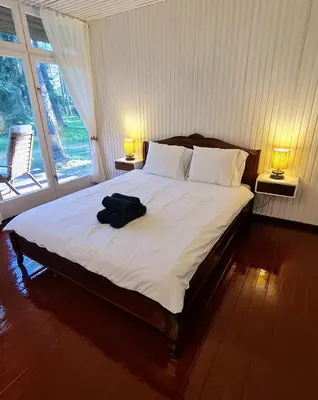 a bedroom with a bed with a backpack on it at Viesuliškės Lakeside Glamping in Lakaja