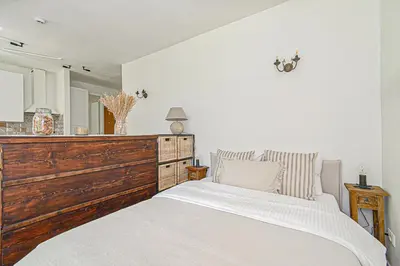 a bedroom with a large bed and a large mirror at Cozy Studio in the heart of Vilnius Old Town in Vilnius