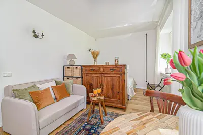 a living room with a couch and a table at Cozy Studio in the heart of Vilnius Old Town in Vilnius