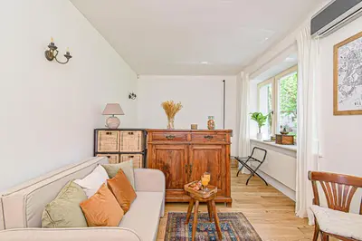a living room with a couch and a table at Cozy Studio in the heart of Vilnius Old Town in Vilnius