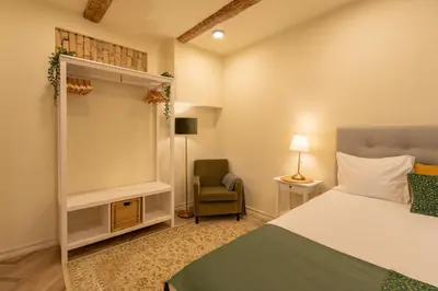 a bedroom with a bed and a chair in it at Taurakalnis apartment in Vilnius