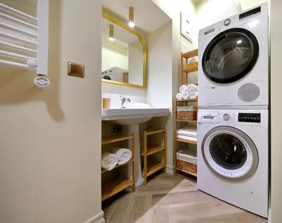 a laundry room with a sink and a washing machine at Taurakalnis apartment in Vilnius