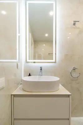 a bathroom with a sink and a mirror at Luxury Central Apartment in Putvinskio street in Kaunas