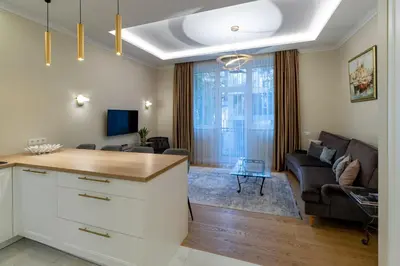 a kitchen and living room with a couch and a table at Luxury Central Apartment in Putvinskio street in Kaunas
