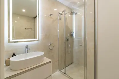a bathroom with a sink and a shower at Luxury Central Apartment in Putvinskio street in Kaunas