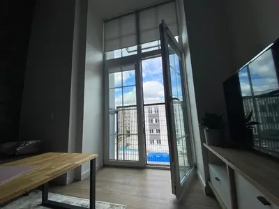 a room with a large window with a view of a building at Radio city loft in Kaunas
