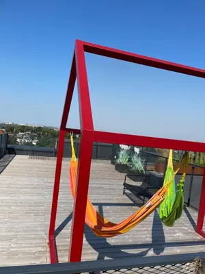 a red and yellow hammock on a deck at Radio city loft in Kaunas