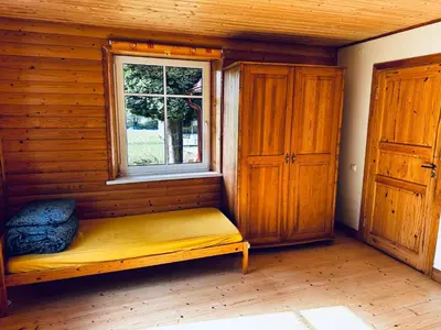 a bench in a room with a window at Scout valley in Totoriškis