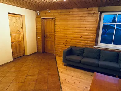 a living room with a couch and a window at Scout valley in Totoriškis
