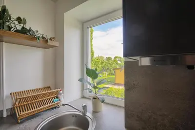 a kitchen with a sink and a window at Modern and cozy flat in Druskininkai