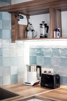 a kitchen counter with a blender and a toaster at Vingriu Street Apartment by Reside Baltic in Vilnius