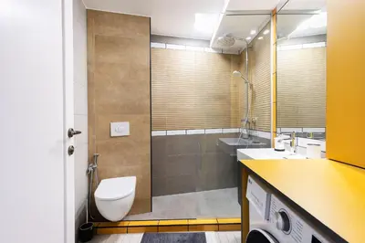 a bathroom with a toilet and a sink and a shower at Vingriu Street Apartment by Reside Baltic in Vilnius