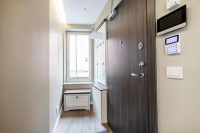 a small hallway with a window and a door at Vingriu Street Apartment by Reside Baltic in Vilnius