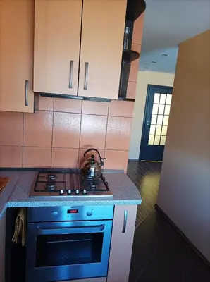 a kitchen with a stove with a tea kettle on it at Centrinio parko apartamentai in Šiauliai