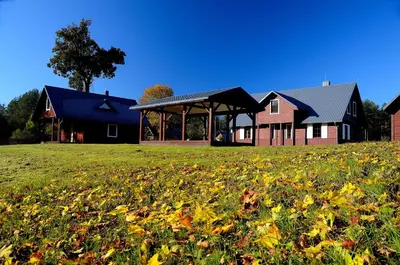 a house with a grass field in front of a house at Dzūkijos uoga in Viršurodukis
